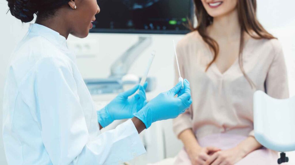 A female patient having a discussion with her OBGYN in a medical office.