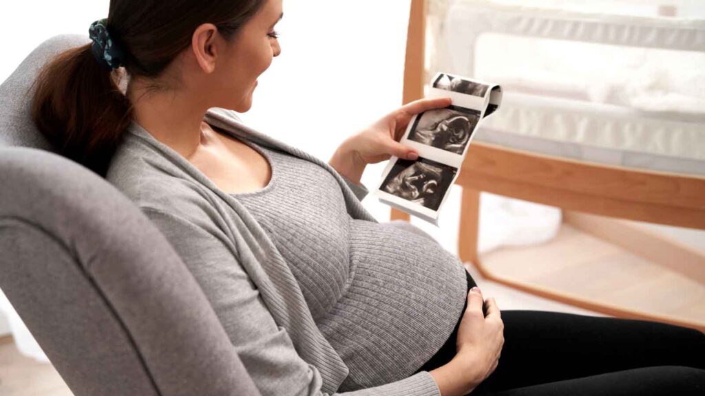 A soon-to-be mom holding an ultrasound image.