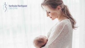 Mother holding her young child in a bedroom.