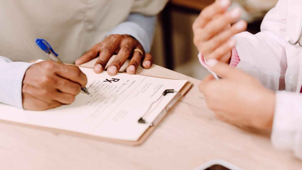 Woman speaking with a medical specialist in a clinic.