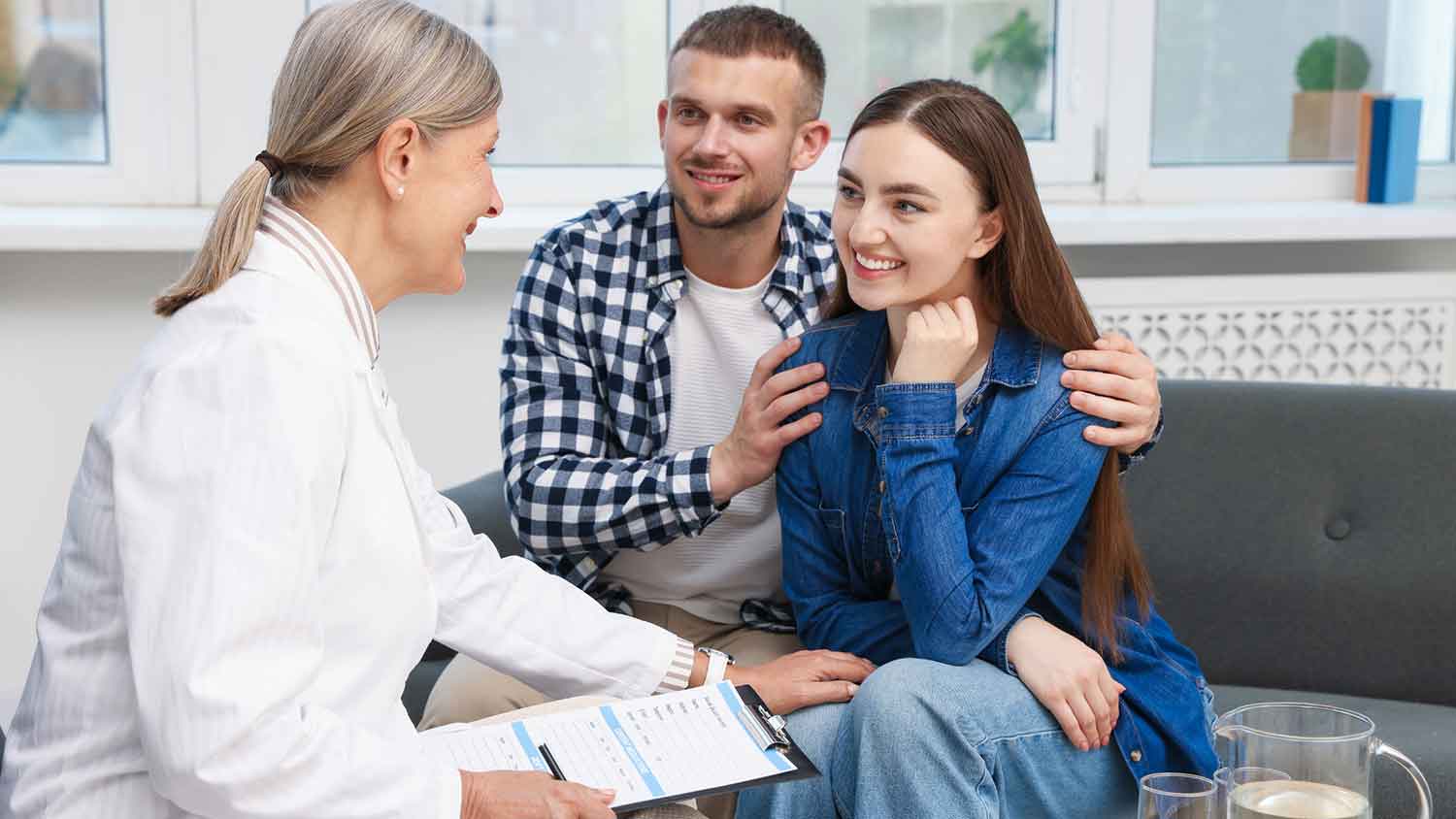 A couple discussing results with a doctor in a medical office.